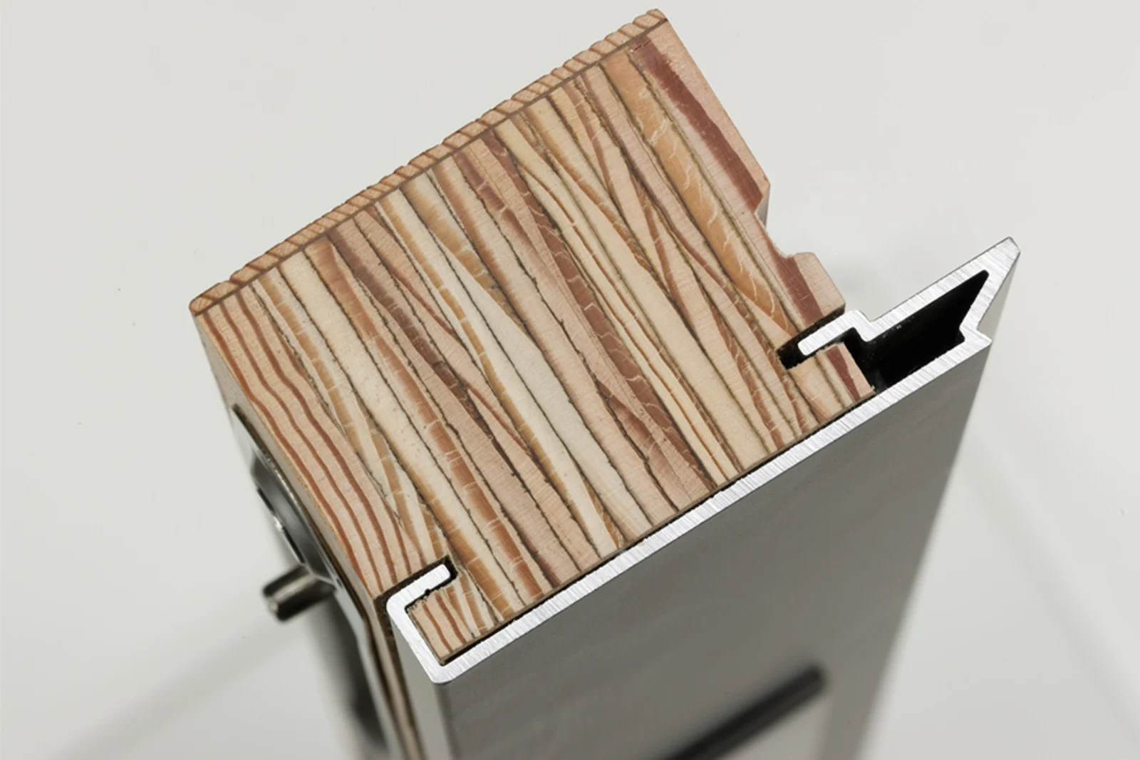 Cutaway of a clad wood window frame showing the solid wood core and metal exterior cladding