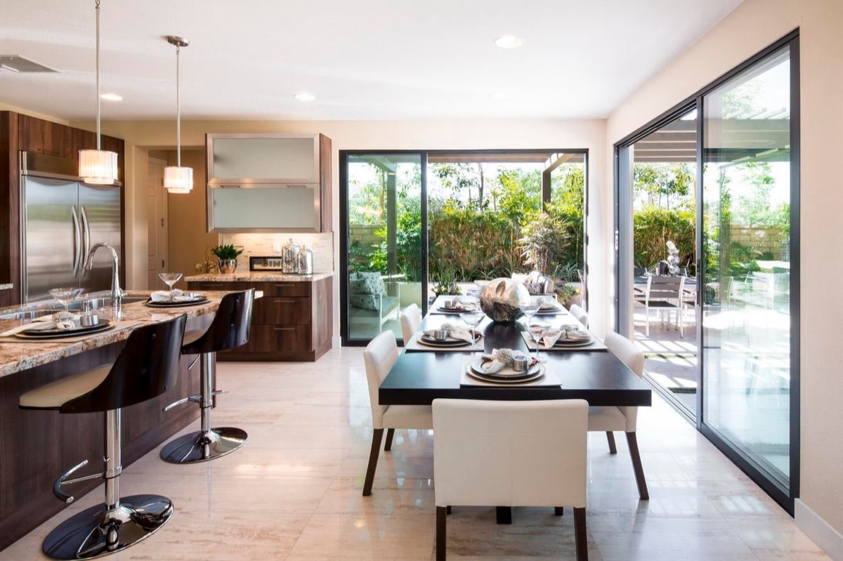 Milgard AX450 aluminum moving glass wall opening a living room to a patio