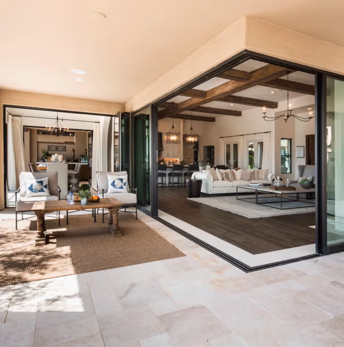 Milgard AX650 aluminum moving glass wall opening a modern home to a pool deck