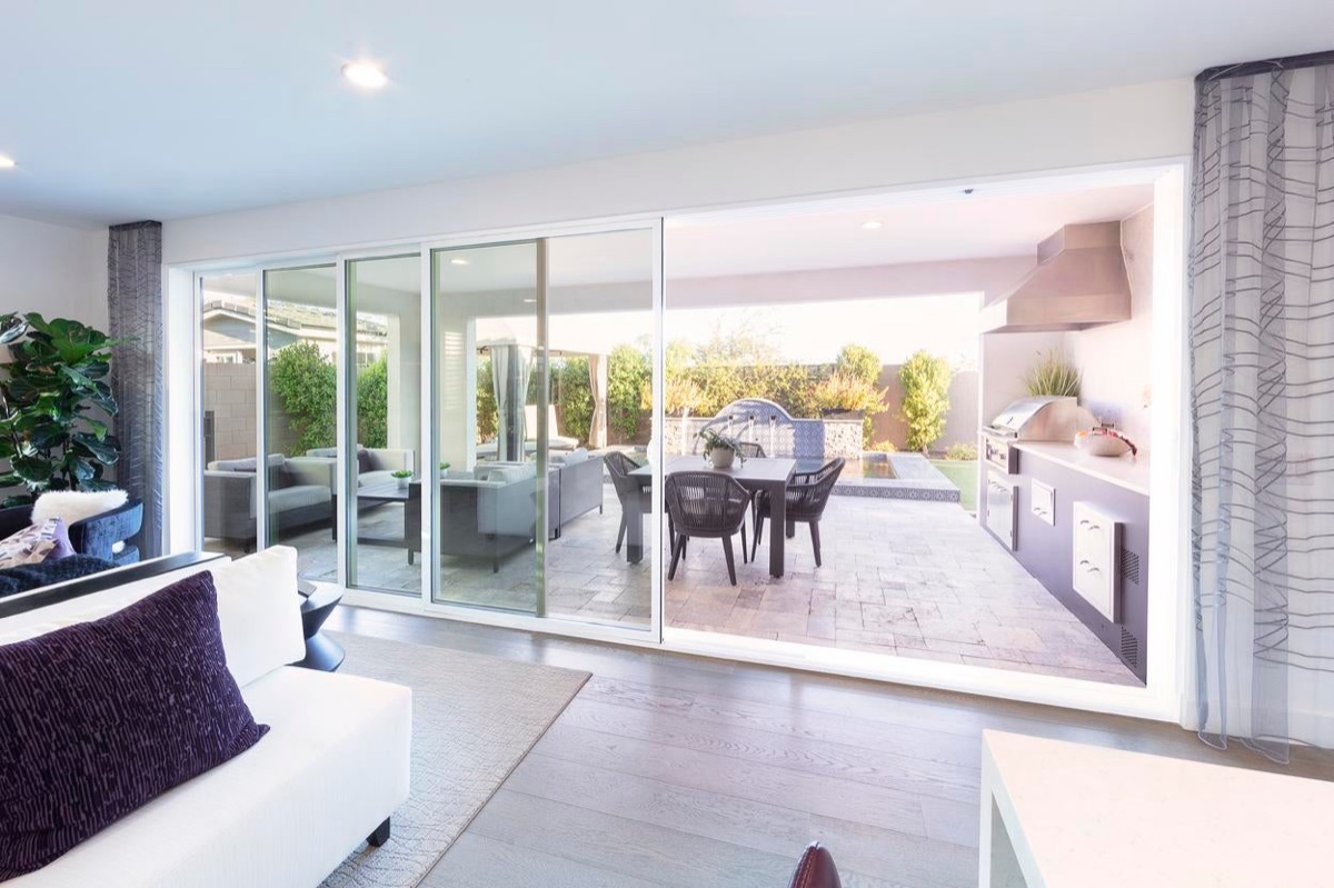 Milgard VX350 vinyl moving glass wall stacked open to a patio