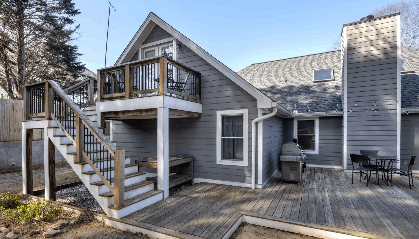 Weathered, graying wood deck and stairs before replacement